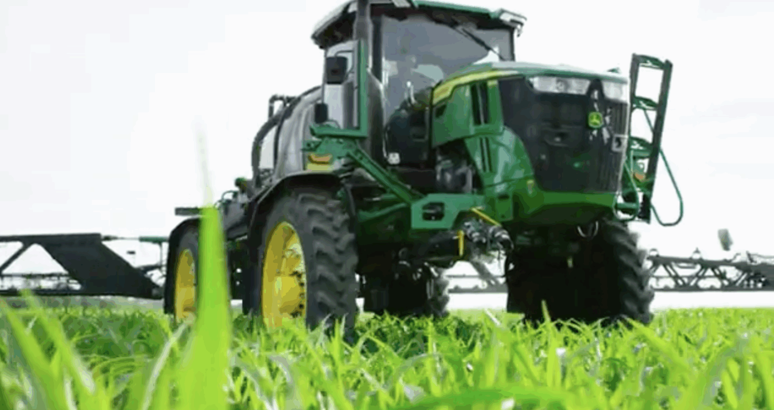Front view of a JD tractor with See & Spray Premium sprayer attached.